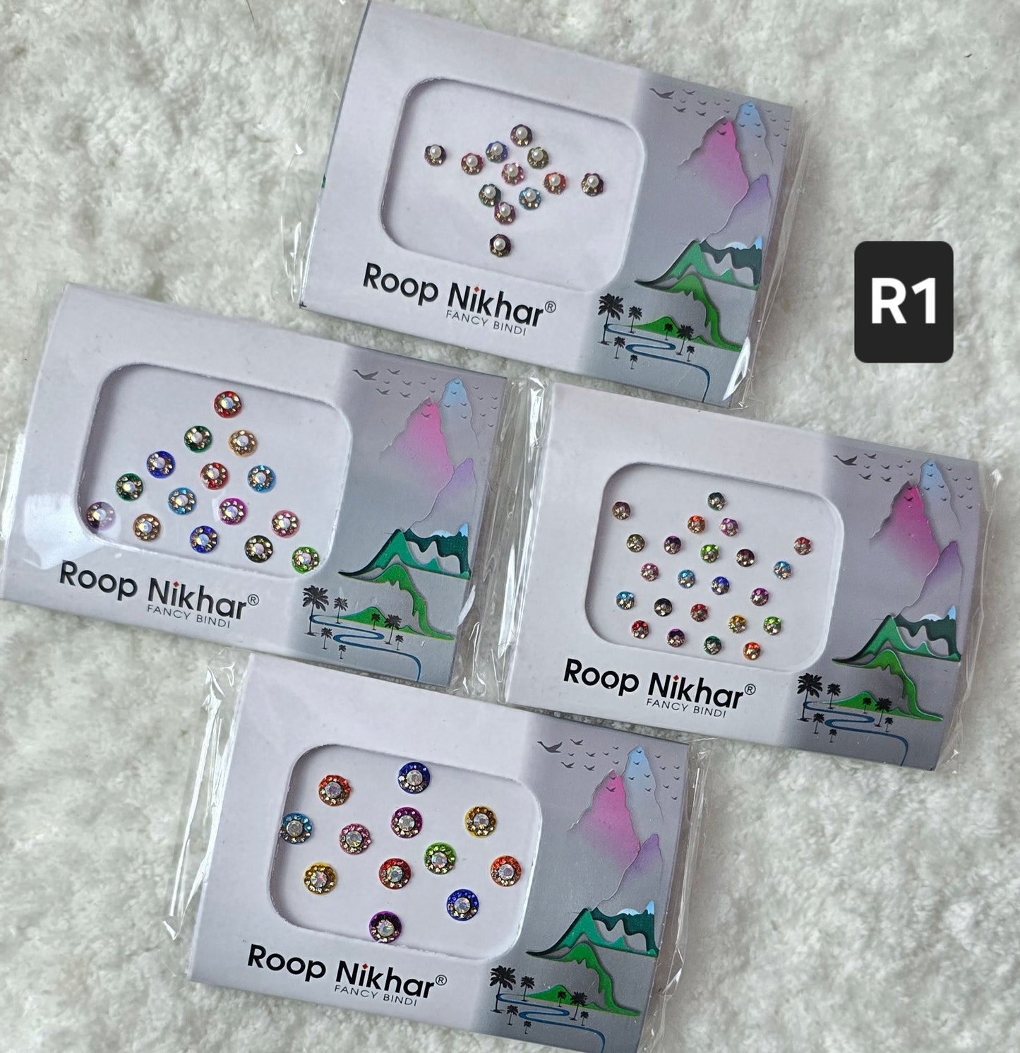 RoopNikhar pack of 4 fancy bindi . Round shape , multicolor.