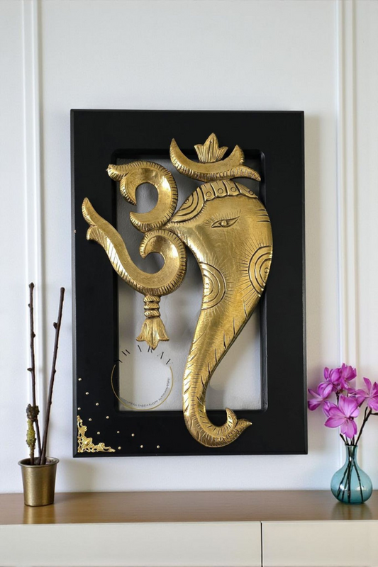 Brass sheet cladding on wood carved Om ganesha figurines. Size 18 by 12 inch. Framed for wall mounting.