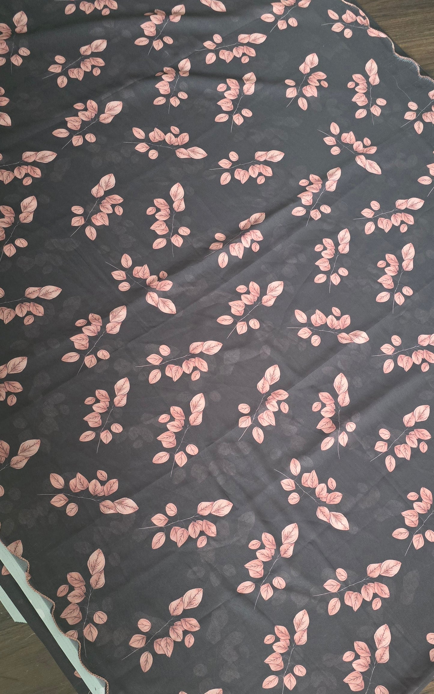 soft weightless Chiffon saree with black base and skin color leaves all over. Comes with stitched blouse.