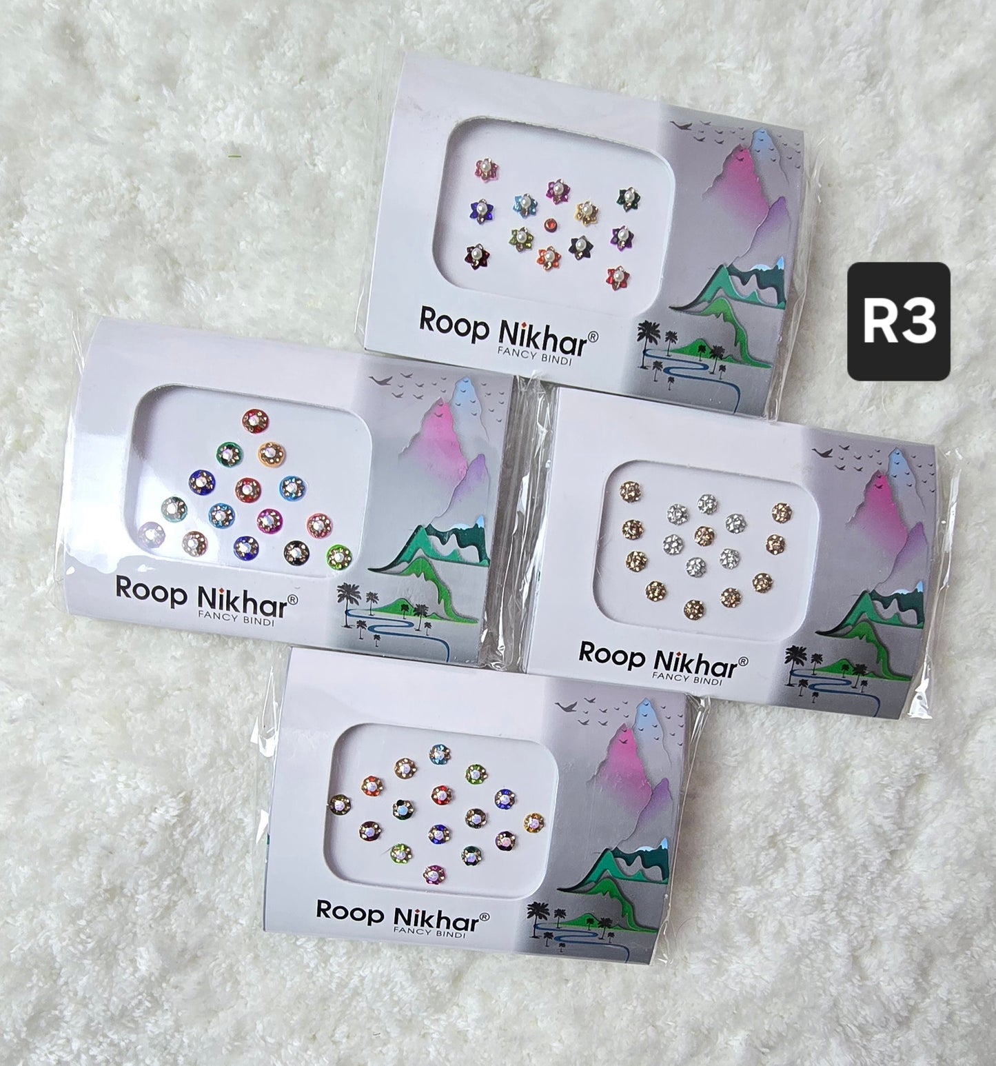 RoopNikhar pack of 4 fancy bindi . Round shape , multicolor.