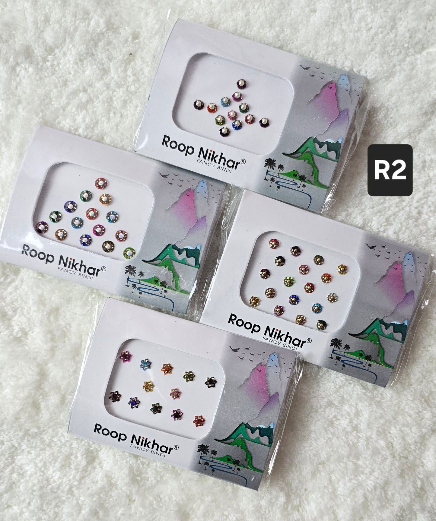 RoopNikhar pack of 4 fancy bindi . Round shape , multicolor.