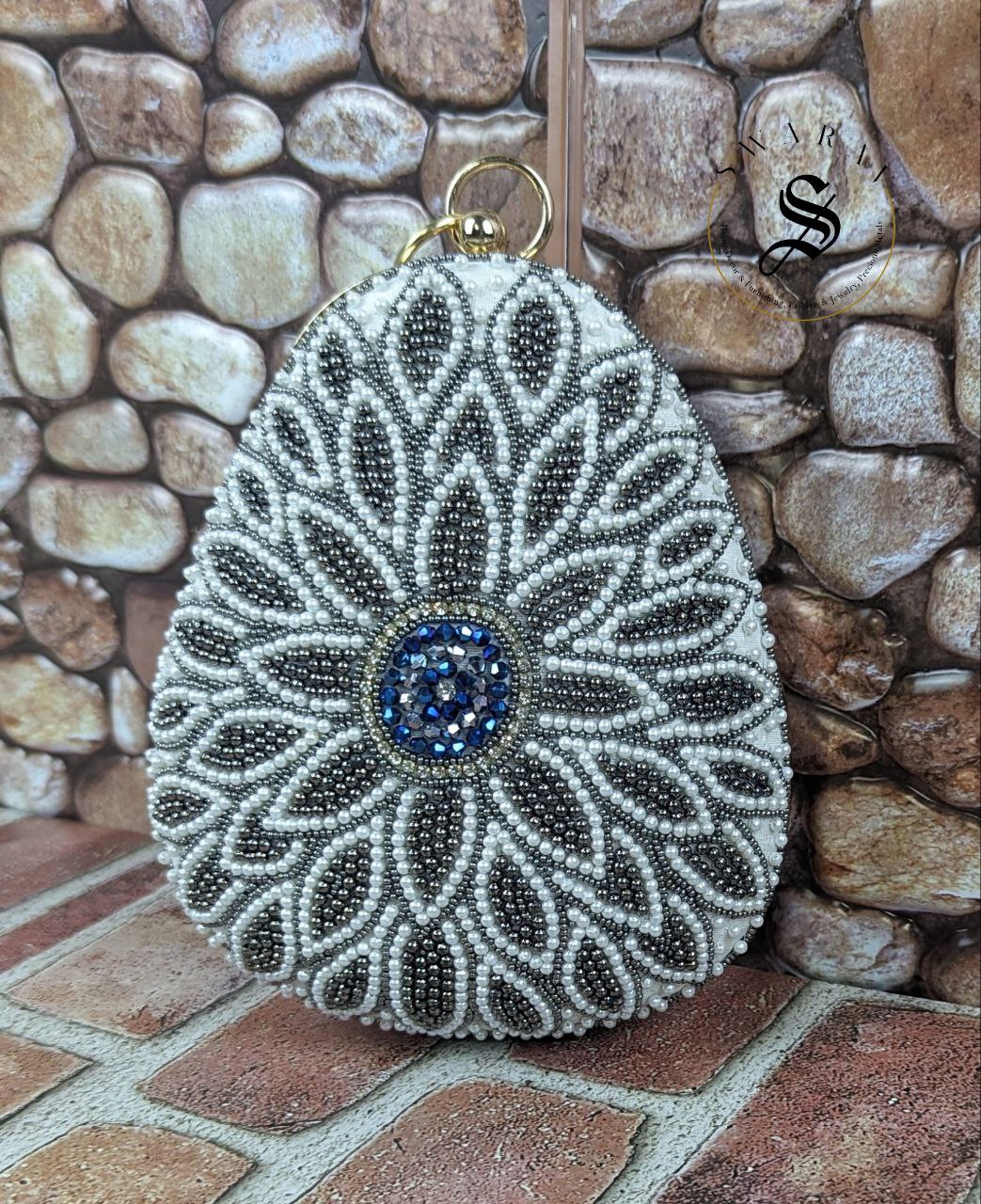 Coconut shape party clutch with floral white and ash color beads.