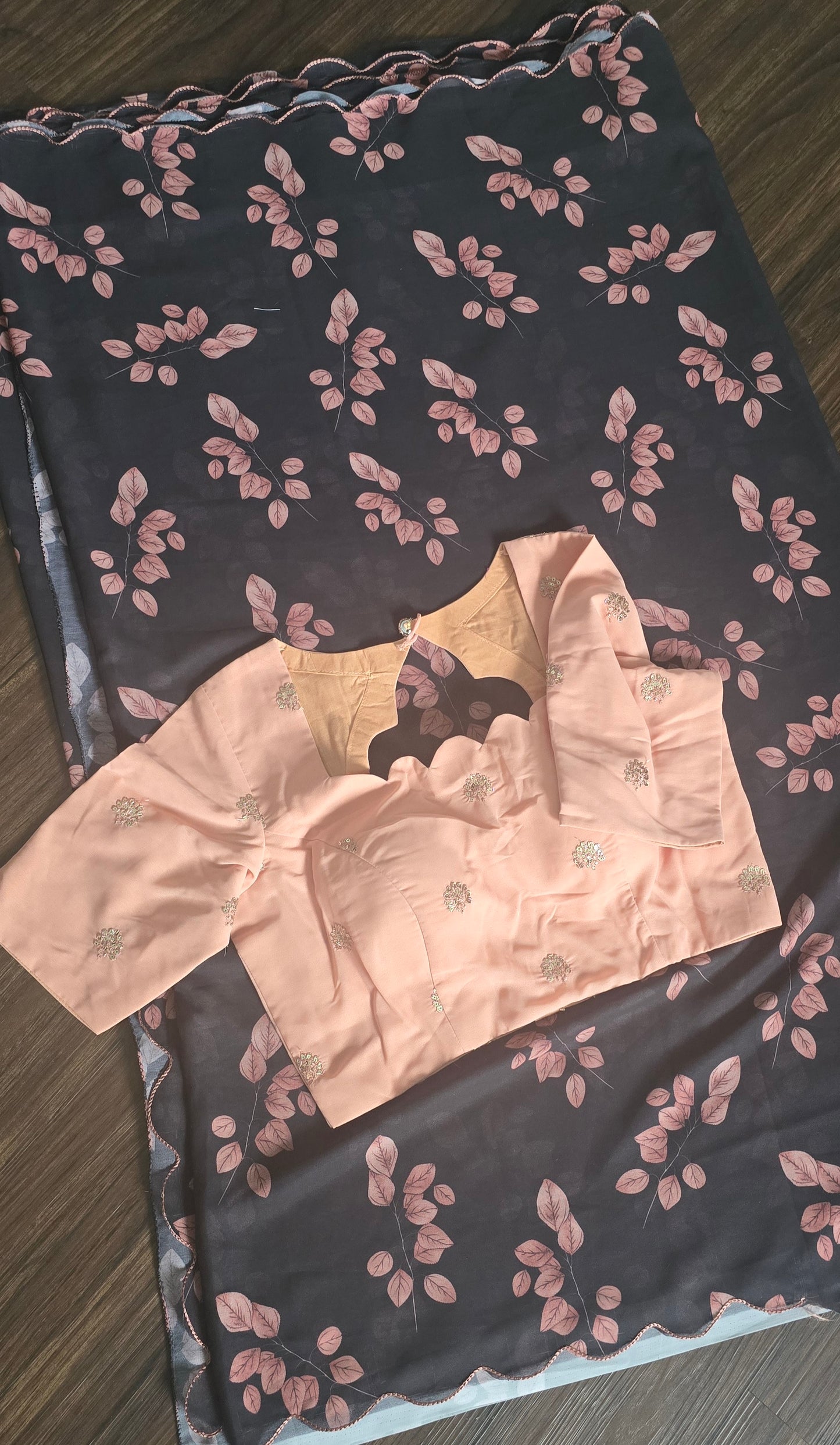 soft weightless Chiffon saree with black base and skin color leaves all over. Comes with stitched blouse.