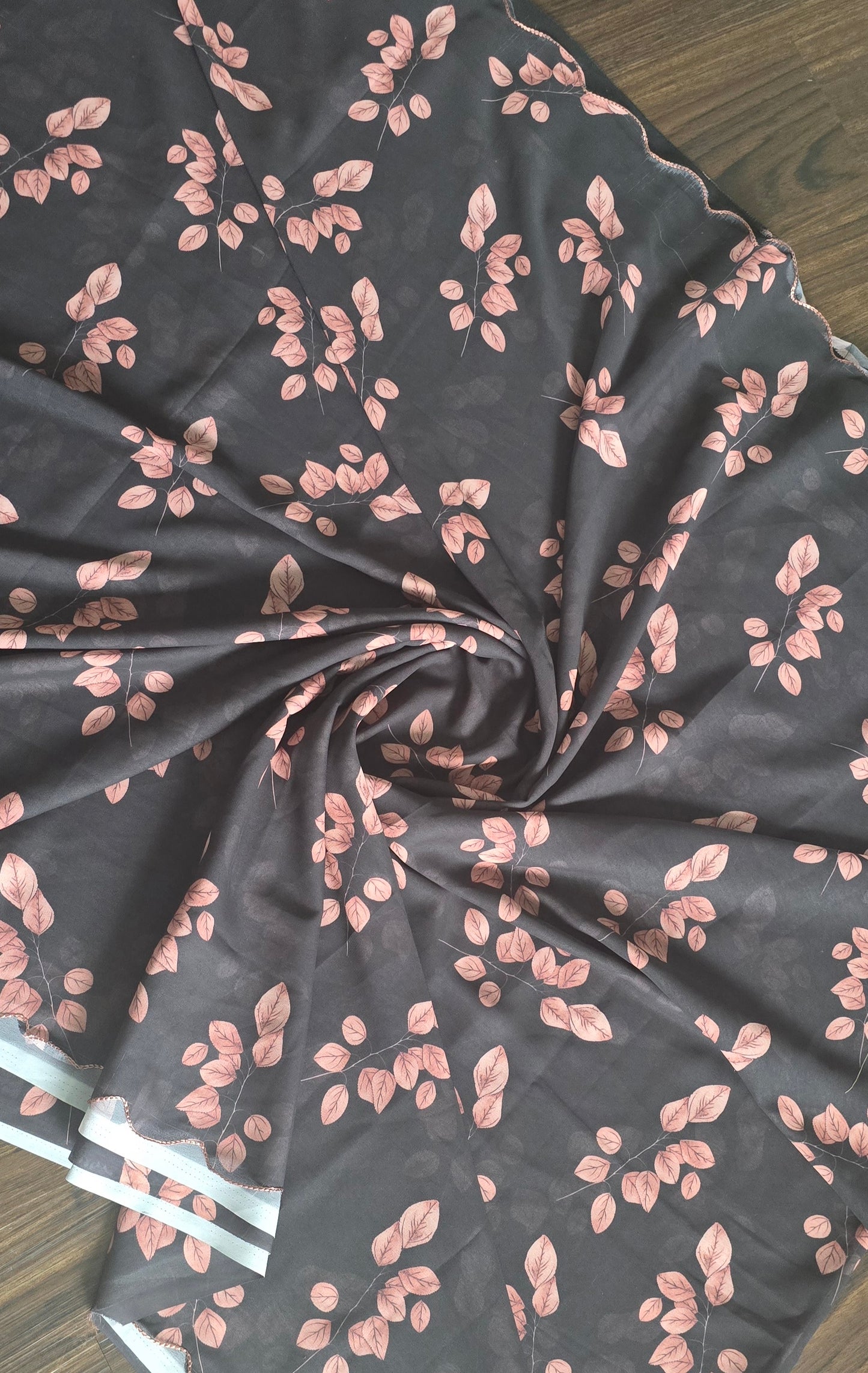 soft weightless Chiffon saree with black base and skin color leaves all over. Comes with stitched blouse.