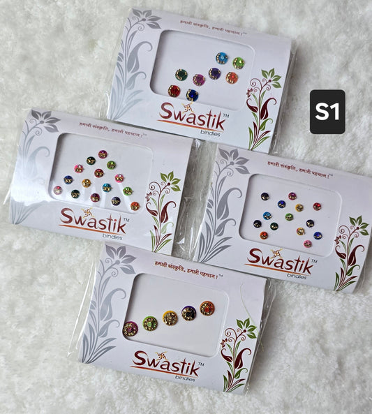 Swastik - Pack of 4 fancy Bindi, assorted size, shape and colors in each pack.
