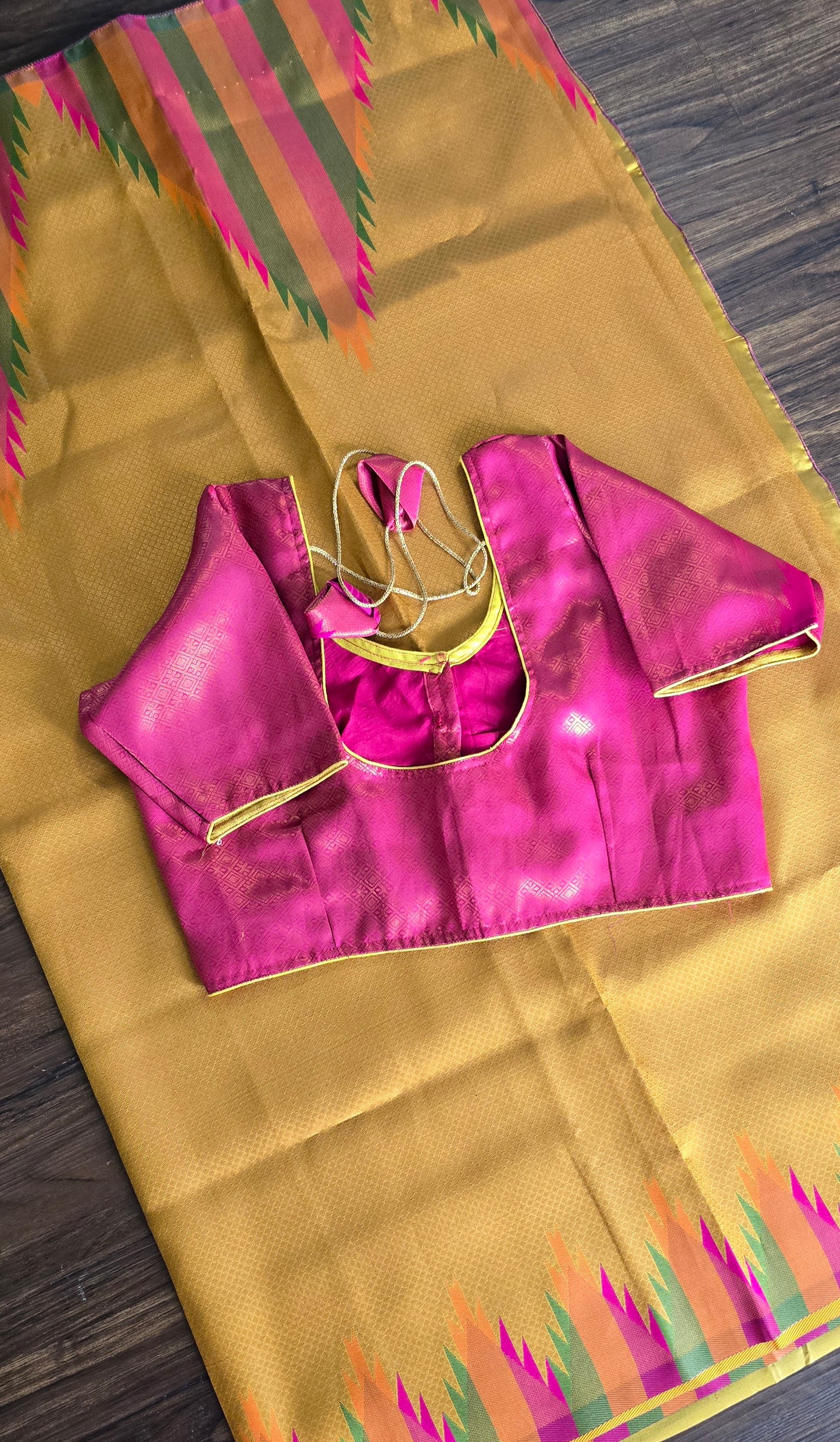 Golden yellow temple border semi silk saree with majenta Jacquard stitched blouse. Code - SAR101