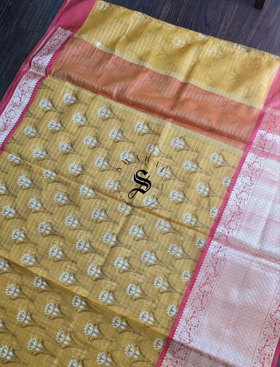 Organza floral silk saree with zari weave kanchi style skirt border and stitched blouse.